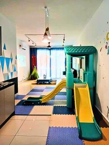 a play room with a slide and a playground at Daya Fun Kids Homestay by SR Home in Johor Bahru