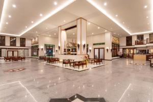 a lobby with tables and chairs in a building at Jomtien Thani Hotel in Jomtien Beach +141 photos