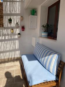 a bed sitting in a corner of a room at Casa Mia in Mola di Bari