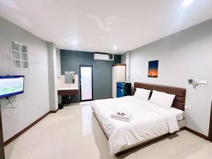 a bedroom with a bed and a flat screen tv at ภูมิพิมานเฮ้าส์ in Udon Thani
