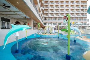 a pool with a water park in a hotel at Jomtien Thani Hotel in Jomtien Beach