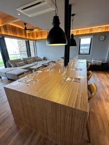 a large wooden table with wine glasses on it at ZABOCON YOICHI Villa in Yoichi
