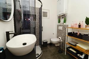 a bathroom with a sink and a shower and a toilet at Fidelis Apartment - Walk to the Beach in Minutes in Novi Vinodolski