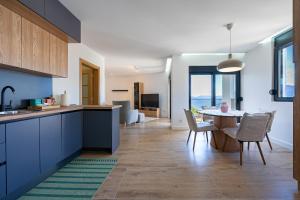 a kitchen and living room with a table and chairs at Barber Apartment in Tivat +12 photos