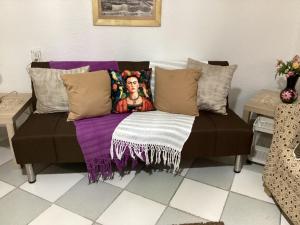 a couch with pillows on it in a living room at Entire accommodation Departamento Mi Mexico in Mexico City