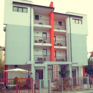 a tall building with an umbrella in front of it at Sea house Afrodita1-rooms in Nesebar