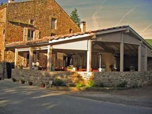 a brick building with a large white garage at Au bord de l'eau Salles sur Cerou in Salles