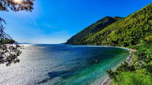a view of a beach next to a mountain at Panorama Traditional Village House in Kamarítsa