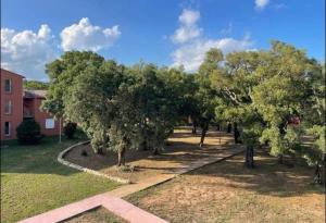 a row of trees in front of a building at Cala Serena Saint Cyprien in Lecci