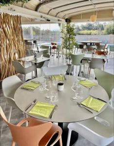 a table and chairs in a restaurant with a view at Cala Serena Saint Cyprien in Lecci