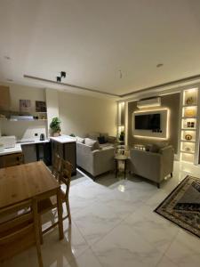 a living room with two couches and a table at منزال in Al Madinah