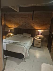 a bedroom with a large bed and two lamps at LOFT COSTANERA 200mts in Encarnación +9 photos