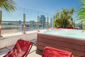 two chairs sitting next to a hot tub on a balcony at Dazzler by Wyndham Rosario in Rosario