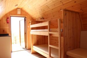 a room with bunk beds in a cabin at Bowdens Crest Glamping Pods -Adults Only in Aller