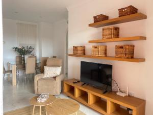 a living room with a television and a table at La casa de Nora Playa Granada in El Varadero