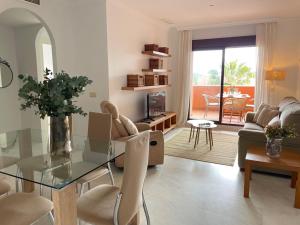 a living room with a glass table and chairs at La casa de Nora Playa Granada in El Varadero