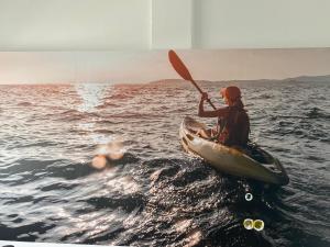 a person in a kayak in the water at Playa Arena Grande in A Guarda