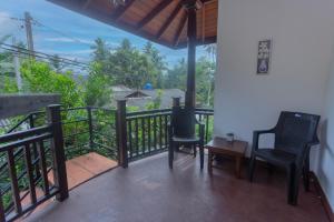 a balcony with chairs and a view of the ocean at 15 Degalla in Dodanduwa