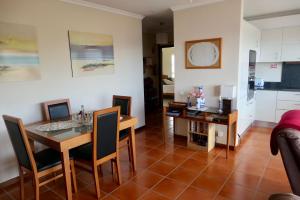 a kitchen and dining room with a table and chairs at Aylevarroo Penthouse in Caniço