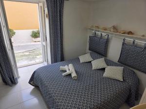 a teddy bear sitting on a bed in a bedroom at Agenzia Aprea Appartamenti in Ponza