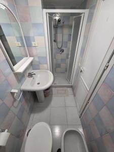 a bathroom with a sink and a toilet and a shower at Agenzia Aprea Appartamenti in Ponza +35 photos