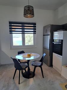 a kitchen with a table and chairs in a room at Robinzon kuća Niko in Zadar +13 photos