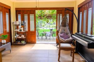 un soggiorno con sedia e pianoforte di Garden Cottage by Utalay Koh Chang a Ban Khlong Son
