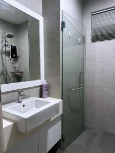 a bathroom with a sink and a shower at Wind Garden Delofts Emporium in Kuching