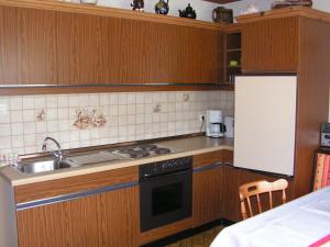 a kitchen with a sink and a stove top oven at Ferienwohnung Linde in Faak am See