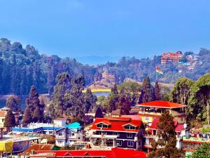 a group of houses in a town with a mountain at Golden Sunview Homestay in Mirik