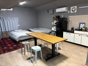 a room with a table and a bed and a kitchen at NagataSeaTime in Yakushima +26 photos
