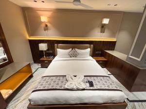 a bedroom with a bed with a bow on it at Hotel Todo in Itānagar