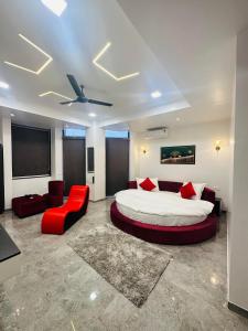 una camera da letto con un letto grande e un divano rosso di Hotel Hill Top Inn -Near Baner Rd Pune a Pune