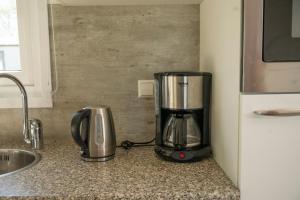a blender sitting on a counter next to a sink at chalet beige in Serooskerke