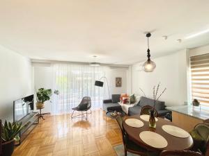 a living room with a table and a couch at Zen house in Athenian Riviera in Athens