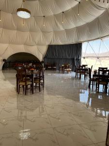 a dining room with tables and chairs in a tent at Rum Star Desert Camp in Wadi Rum