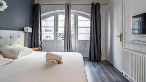 Posteľ alebo postele v izbe v ubytovaní L'Escapade Urbaine - Cosy et central