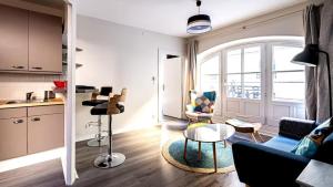 salon z kanapą i stołem w obiekcie L'Escapade Urbaine - Cosy et central w mieście Dijon