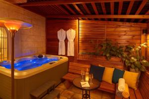 a jacuzzi tub in a wooden room with a table at Mamilla View- Suites & Apt Hotel in Jerusalem