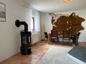 a living room with a wood stove and a table at Apartment BERGfamilie - gemütlich ausgestattet, ruhig und familienfreundlich in Schliersee +10 photos