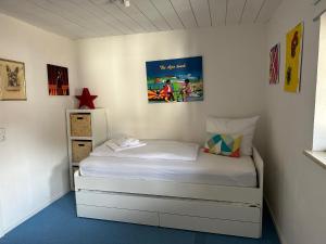 a small bedroom with a white bed in it at Apartment BERGfamilie - gemütlich ausgestattet, ruhig und familienfreundlich in Schliersee