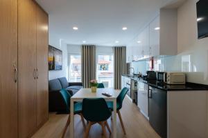 a kitchen and living room with a table and chairs at Live in Aveiro Beira Mar in Aveiro