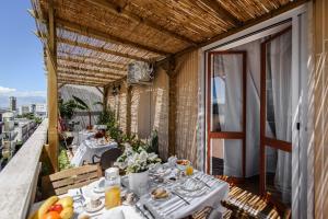 a restaurant with tables and chairs on a balcony at LuxAttico Bed & Breakfast in Lecce