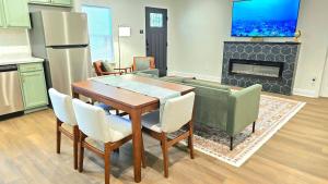 a kitchen with a table and chairs and a fireplace at Charming & Stylish in Mid-Town in Mobile