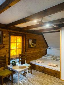 a room with two beds and a table and chairs at Sosenka in Zalas