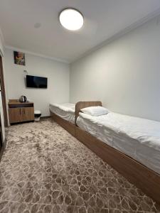 a bedroom with a bed and a flat screen tv at Asman in Naryn +12 photos