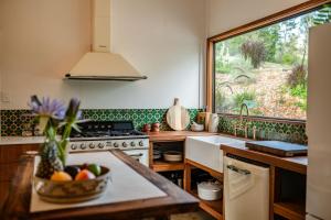 a kitchen with a bowl of fruit on a counter at Off-Grid Eco Cabin in Bellingen