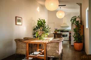 a dining room with a wooden table and chairs at Off-Grid Eco Cabin in Bellingen