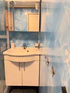 a bathroom with a white sink and a mirror at beautiful apartment in nature in Oldervik +29 photos