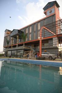 a building with a swimming pool in front of a building at Krishnangan Hotel & Resort in Bikaner